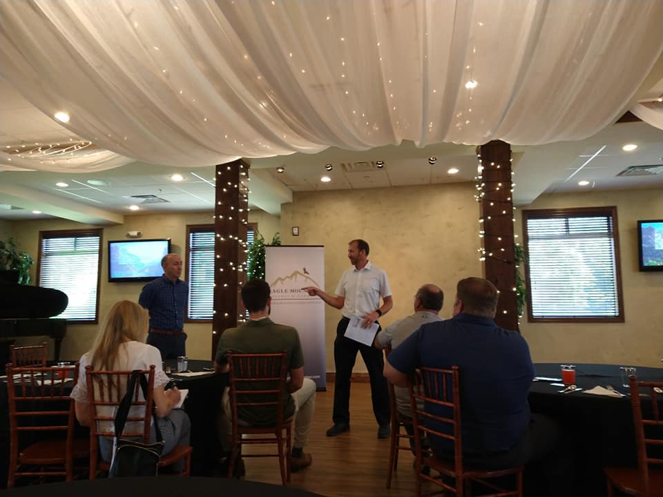 A man is giving a presentation to a group of people