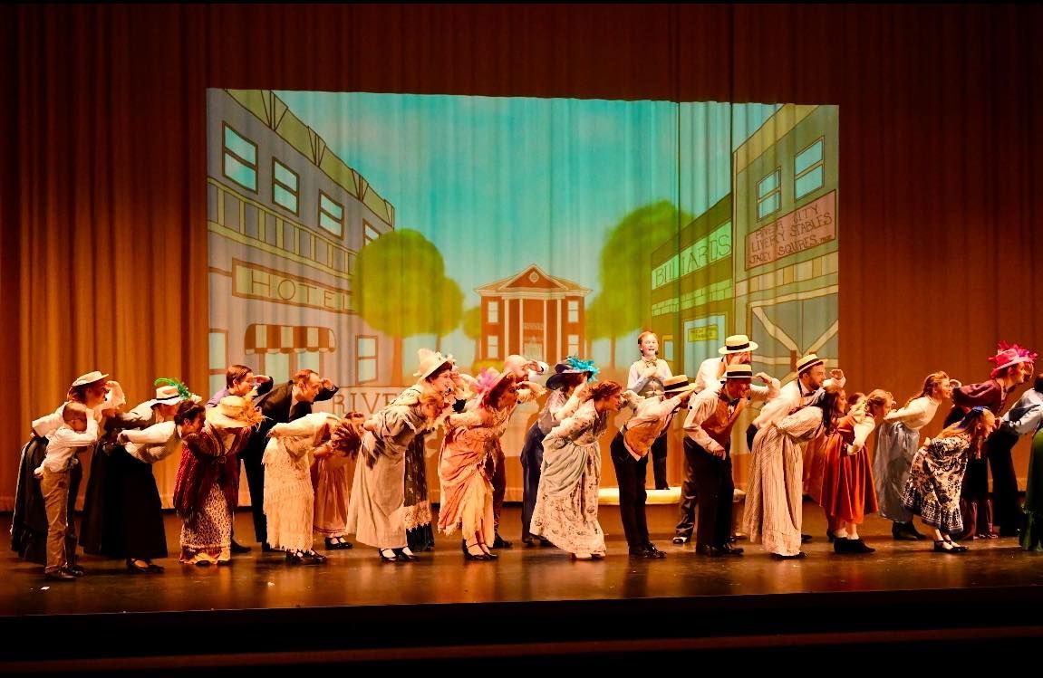 A large group of people are dancing on a stage.