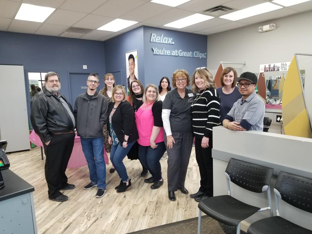 A group of people are posing for a picture in a waiting room.