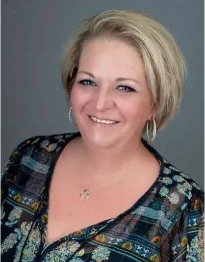 A woman wearing a yellow beret is looking through binoculars