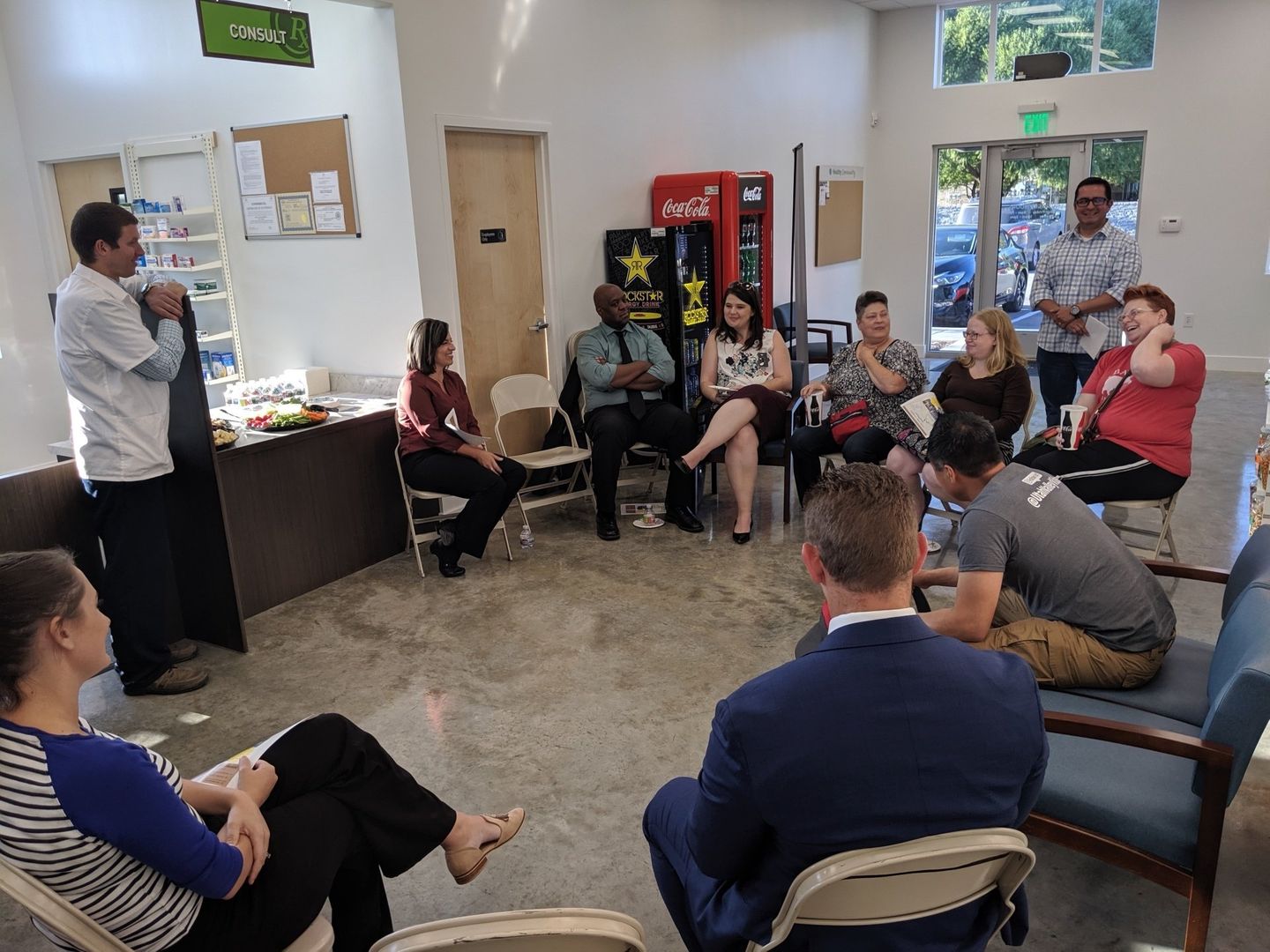 A group of people are sitting in a circle in a room.