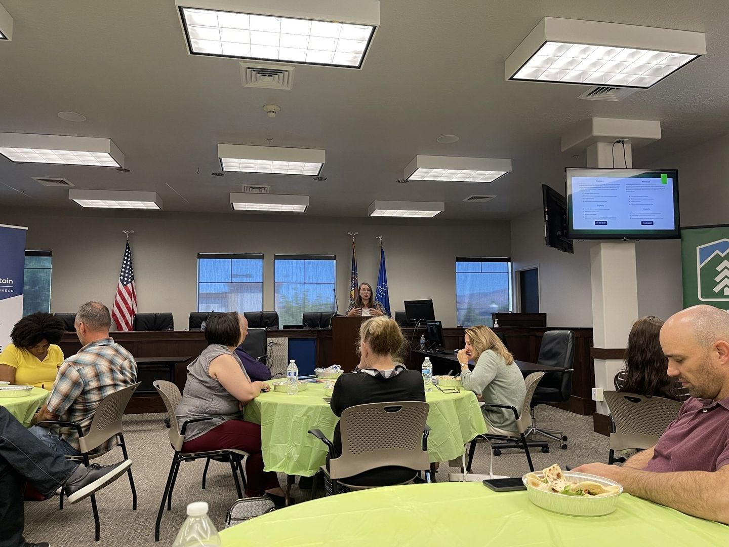 A group of people are sitting at tables in a room.
