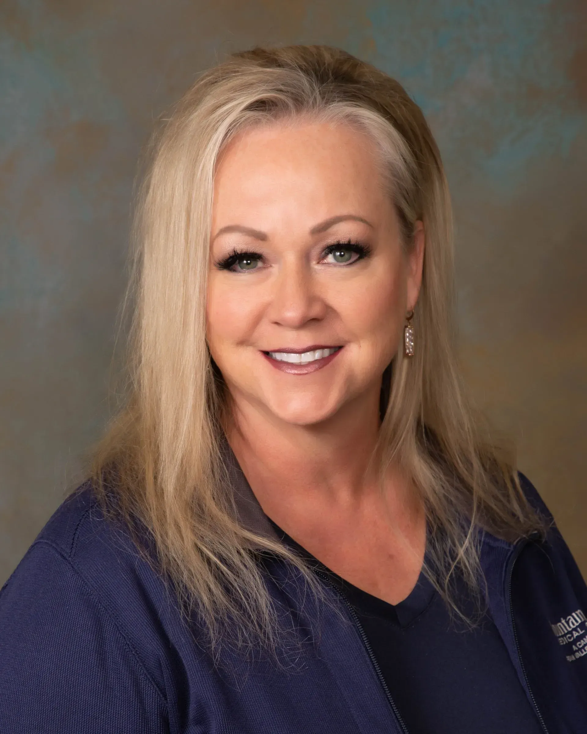 A woman with a braided ponytail is standing in front of a blue sky.