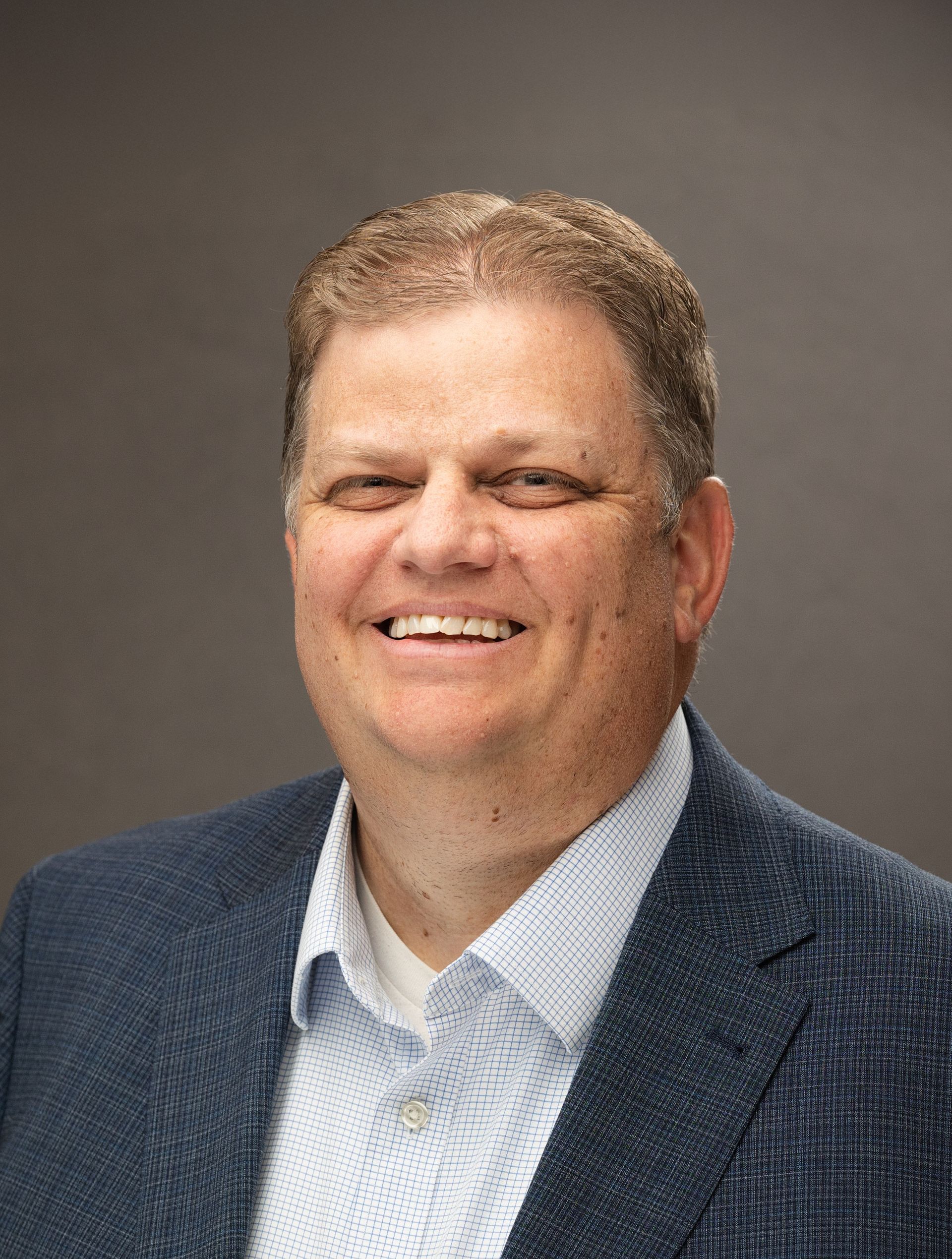 A woman wearing a yellow beret is looking through binoculars