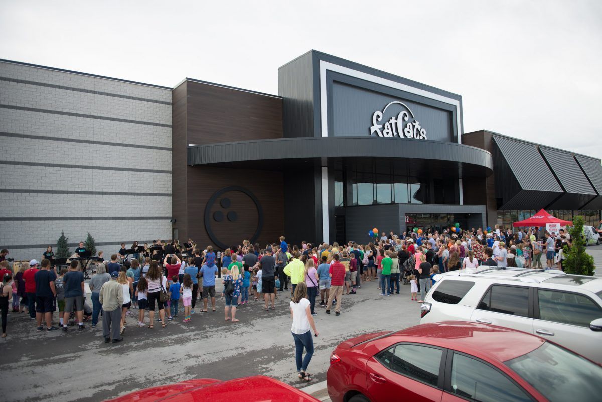 A large group of people are standing outside of a building.