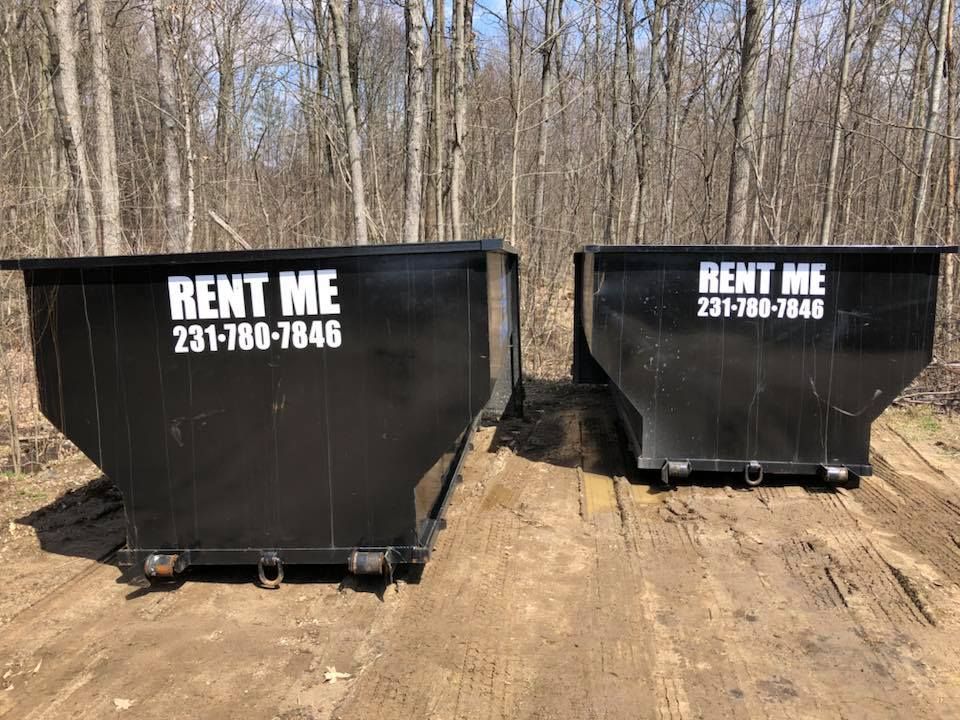 Two black dumpsters with 
