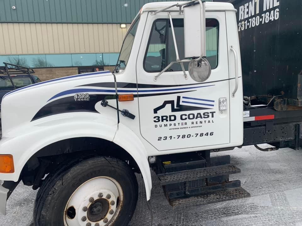 White 3rd Coast dumpster rental truck with blue accents parked outside in snow.