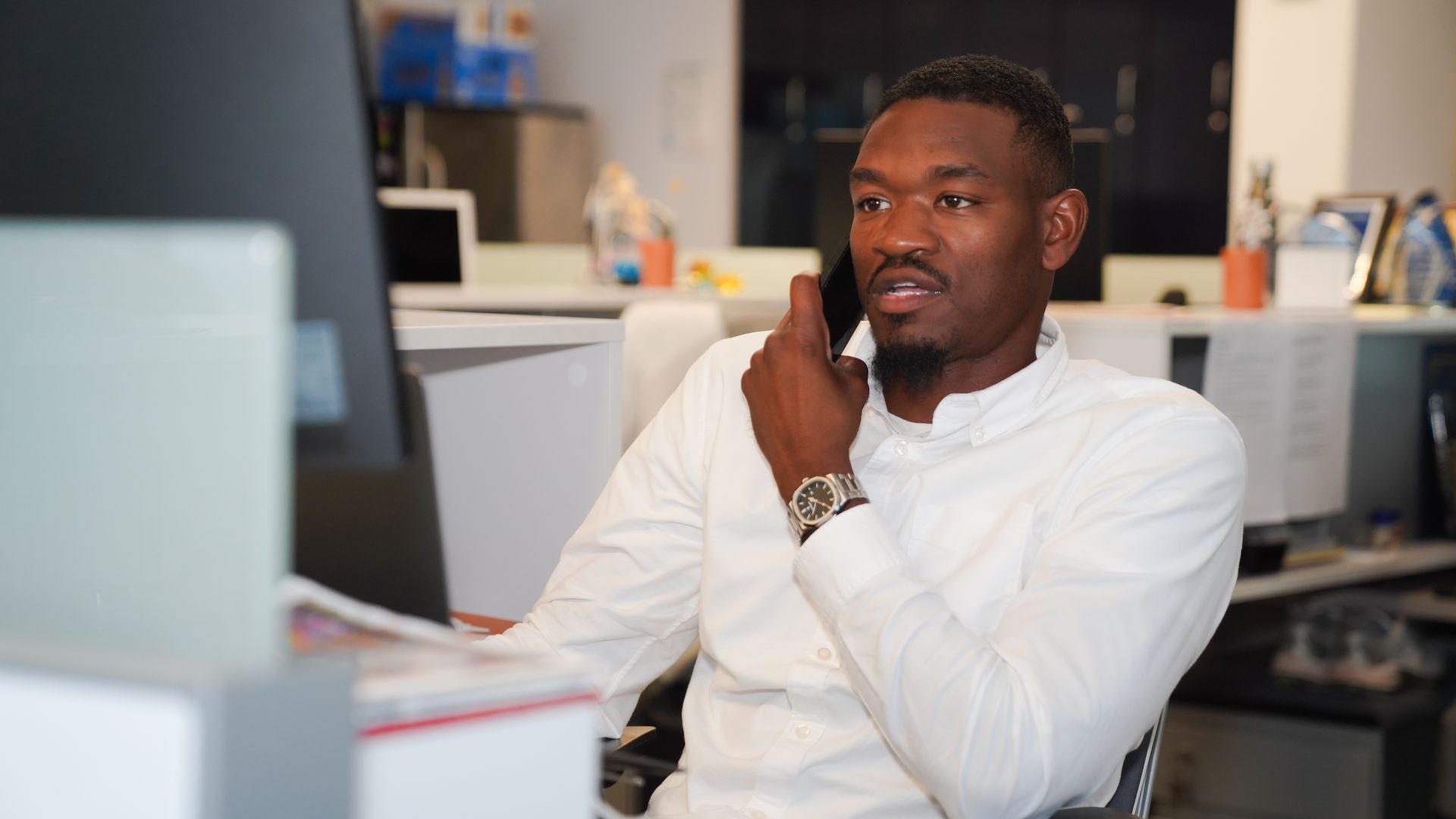 Person receiving a brown paper bag from a person holding a tablet.