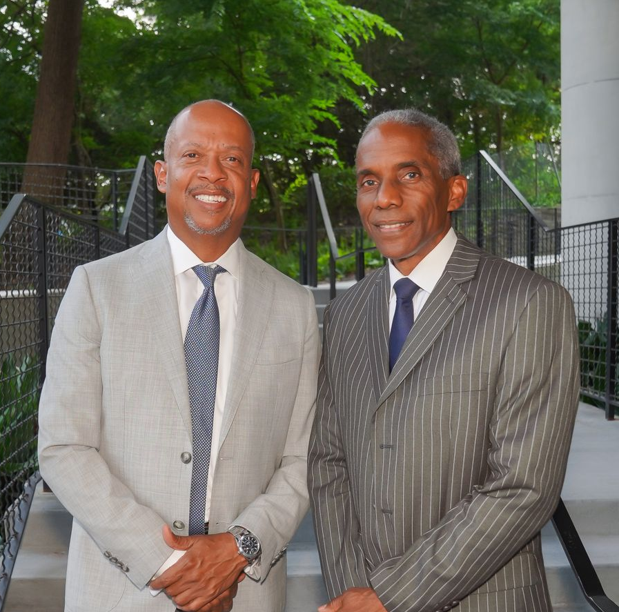 Computer screen displaying a blue and yellow stock market graph with fluctuating lines.