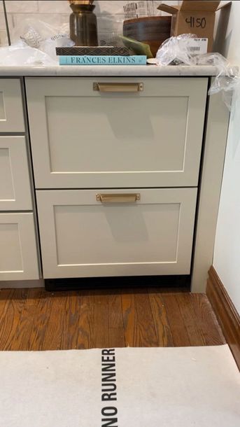 A stainless steel double oven is built into a wall in a kitchen.
