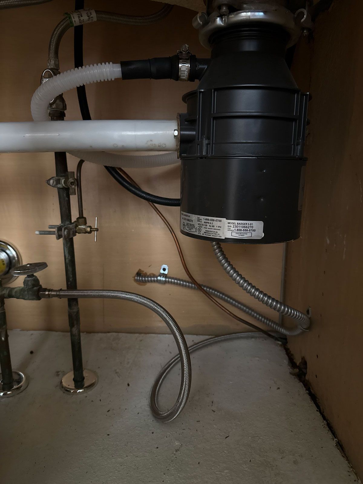 A sink with a garbage disposal underneath it