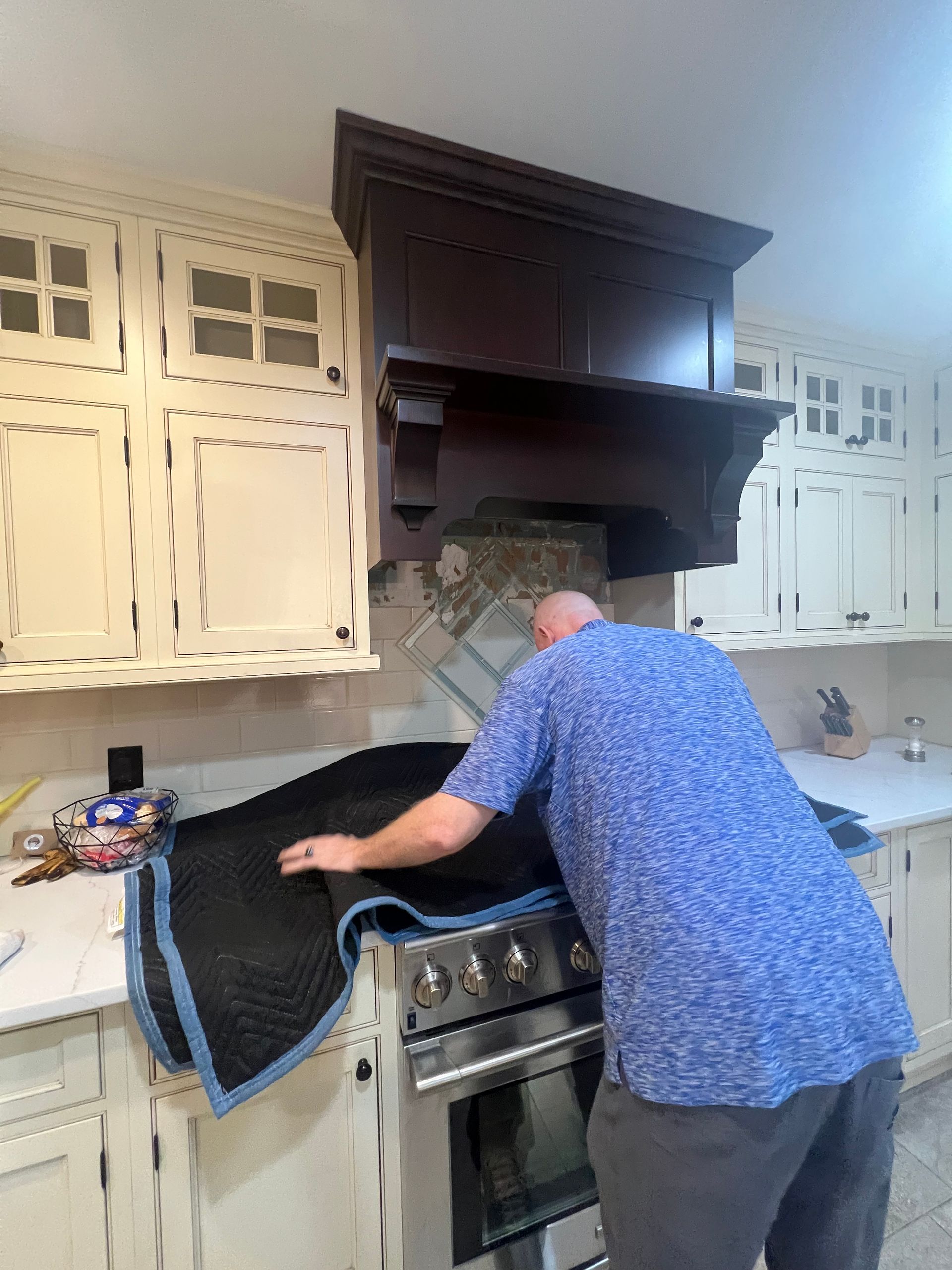 A kitchen with stainless steel appliances and a large refrigerator.