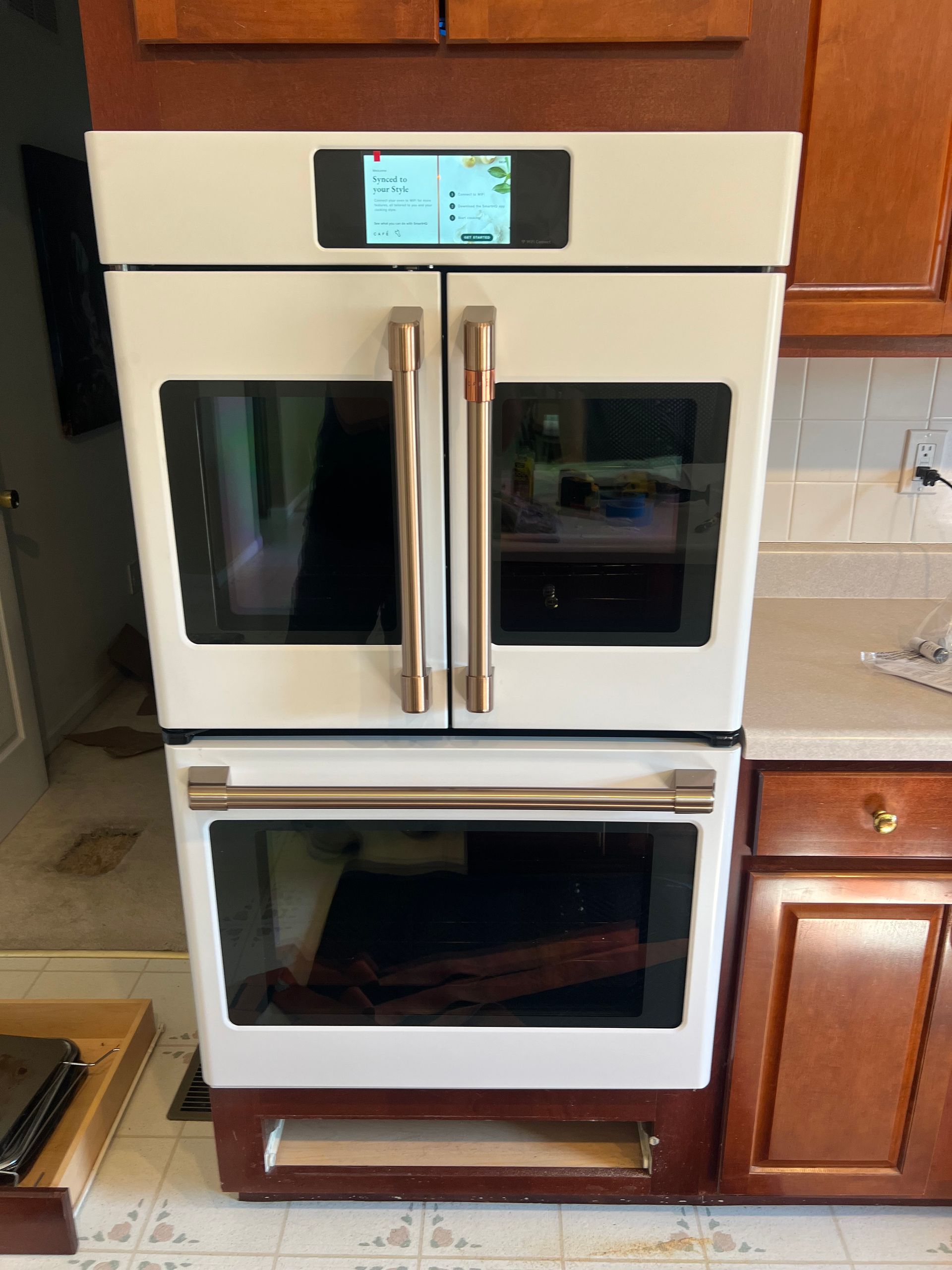 A kitchen with a stainless steel oven and microwave.