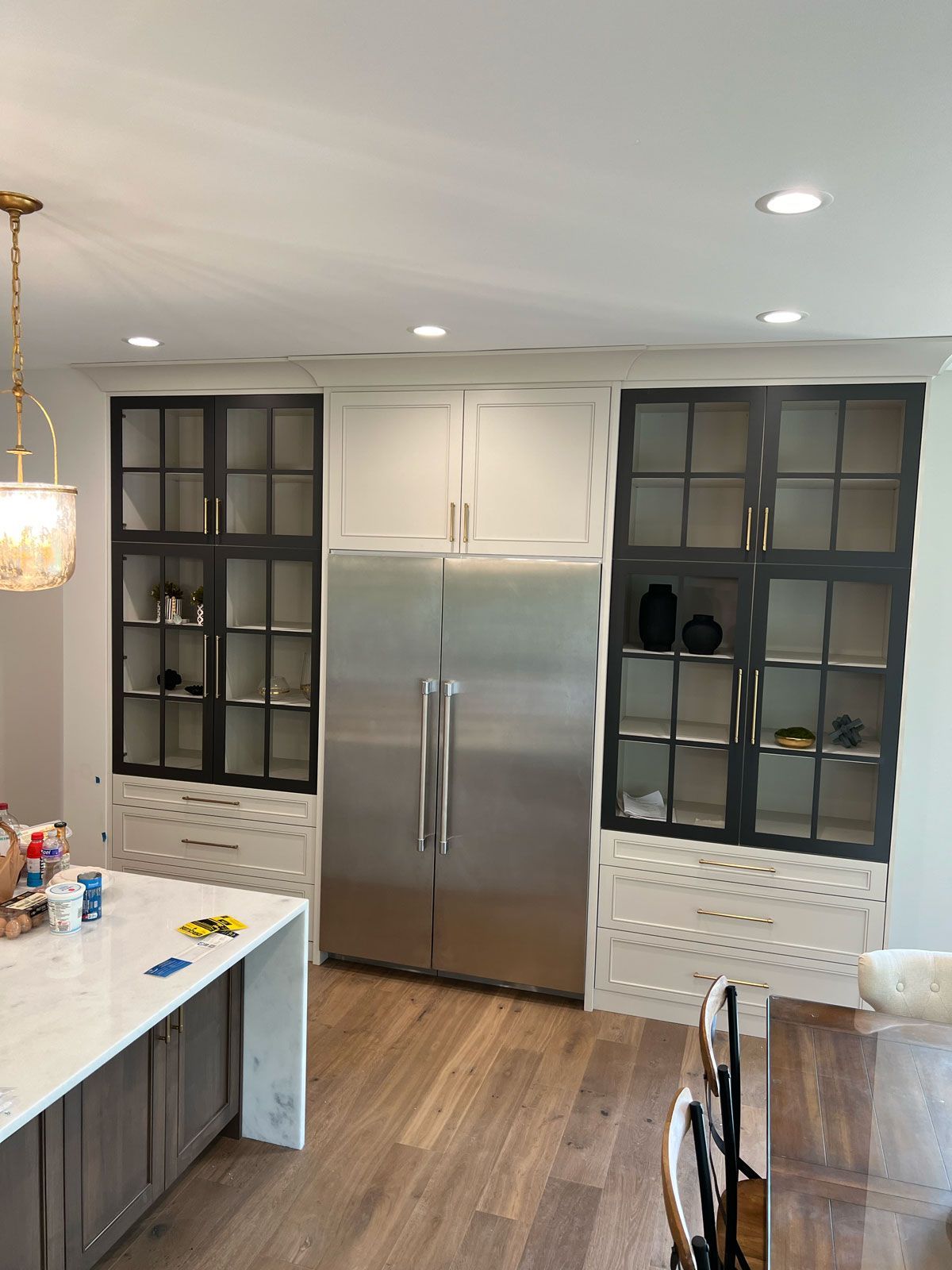 A kitchen with stainless steel appliances and a large refrigerator.