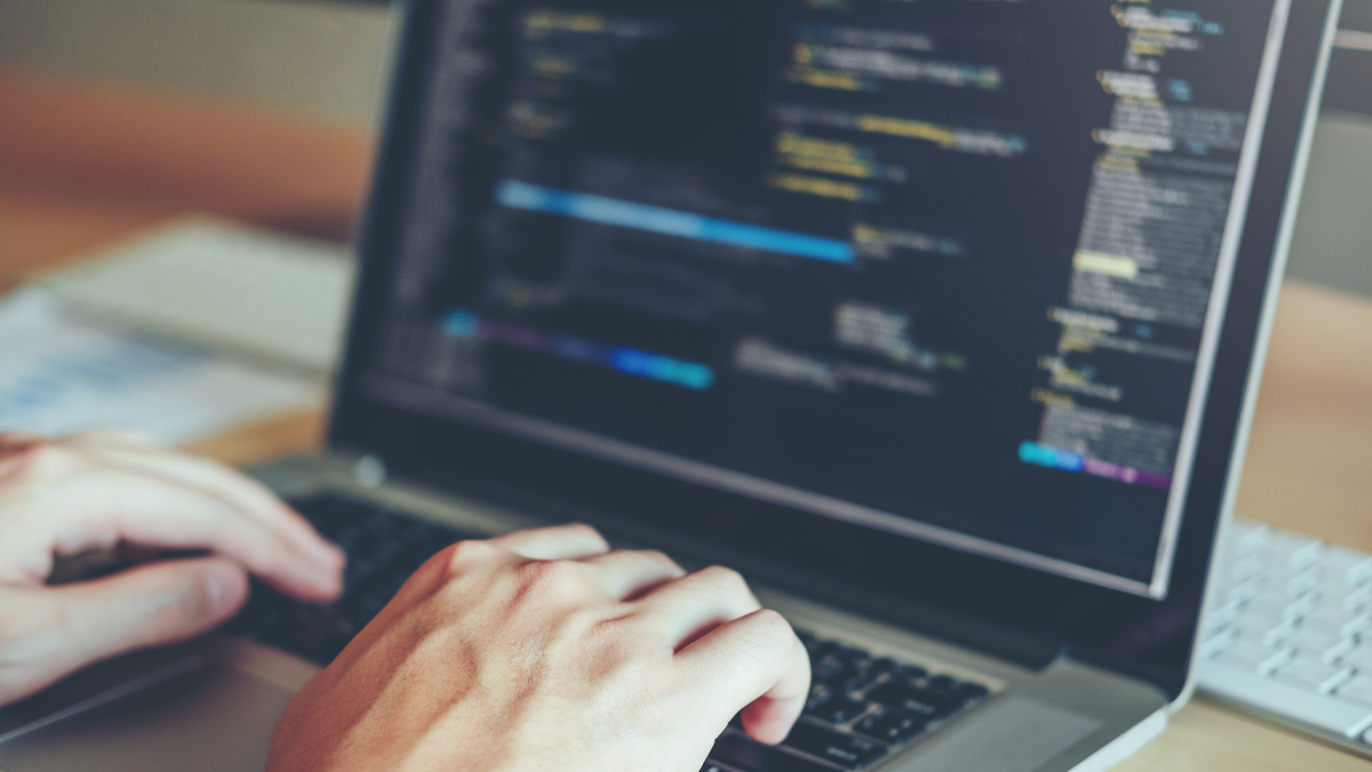 A person is typing on a laptop computer