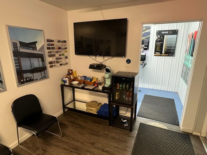 A waiting room with a flat screen tv on the wall.