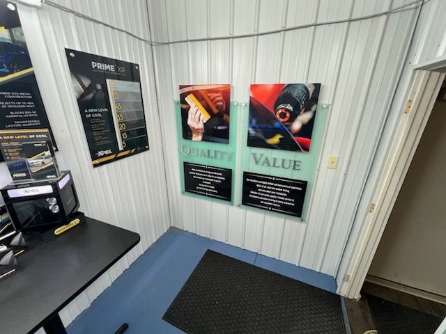 A room with posters on the wall that say quality value