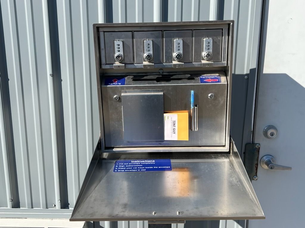 A stainless steel mailbox with the lid open