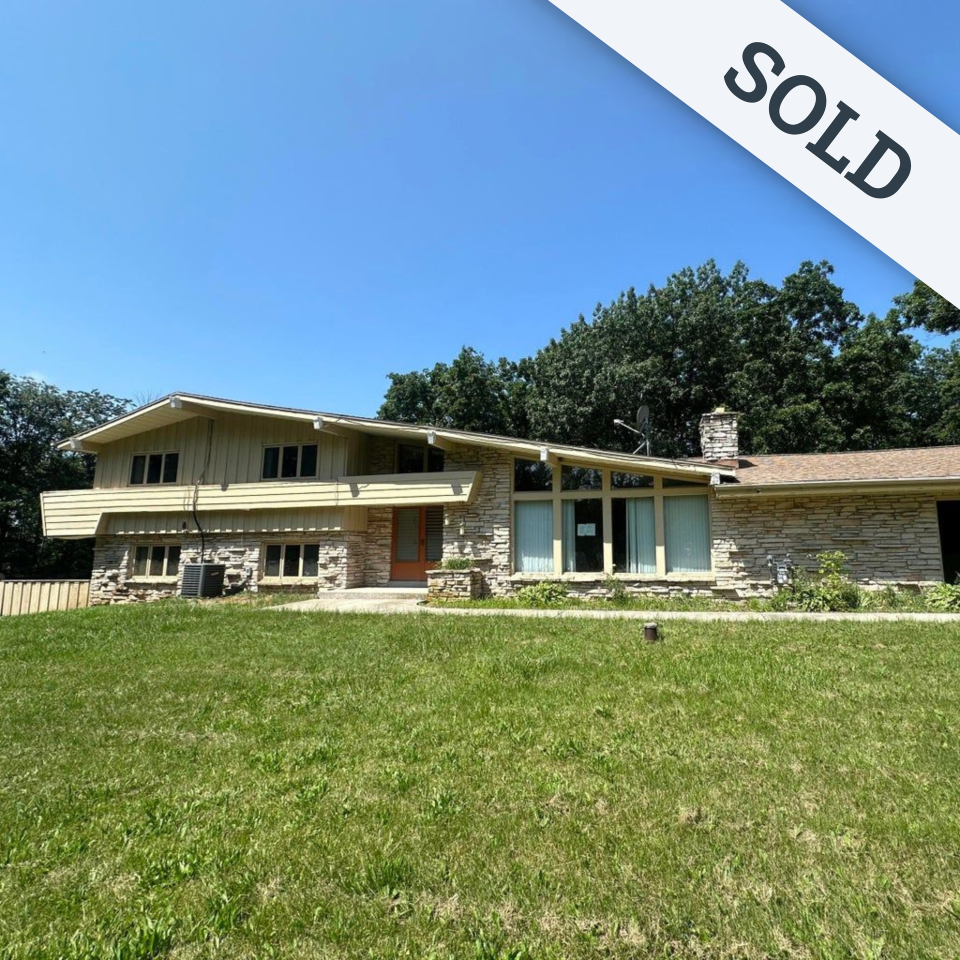 A large house with a large lawn in front of it