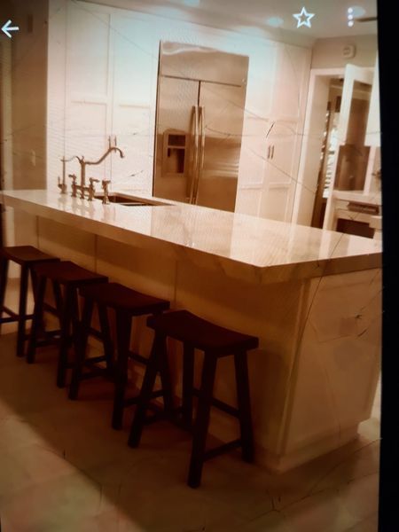 Living room with fireplace, bookshelves, couches, area rug, and staircase.