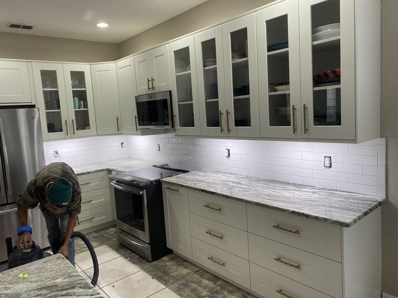 Double brown front doors with glass panes and arched transom window, white trim.