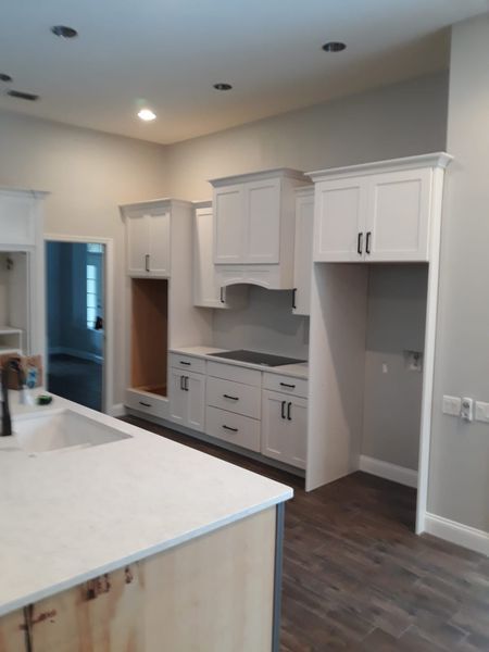 Double brown front doors with glass panes and arched transom window, white trim.