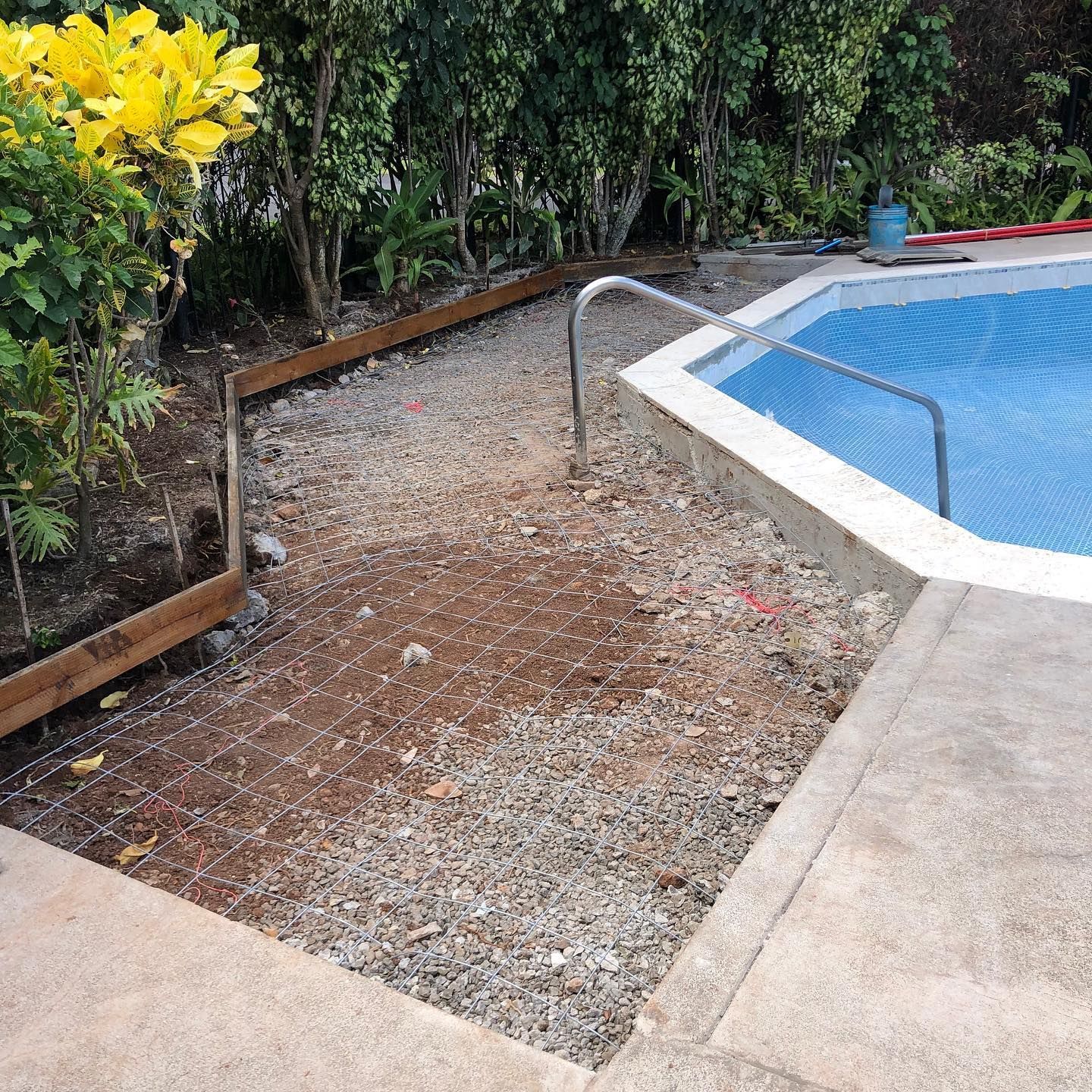 A swimming pool is being built in a backyard