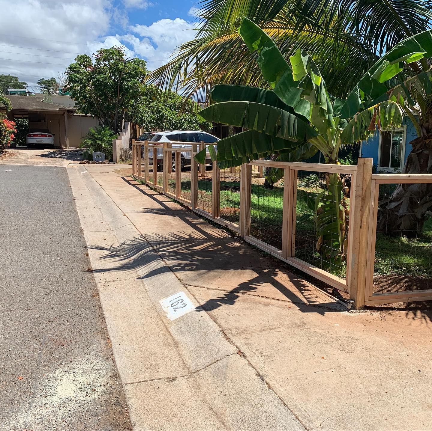 A wooden fence along the side of a road