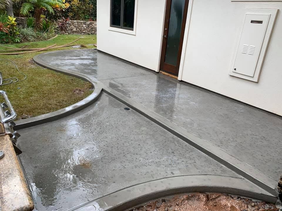 A concrete walkway is being built in front of a house.