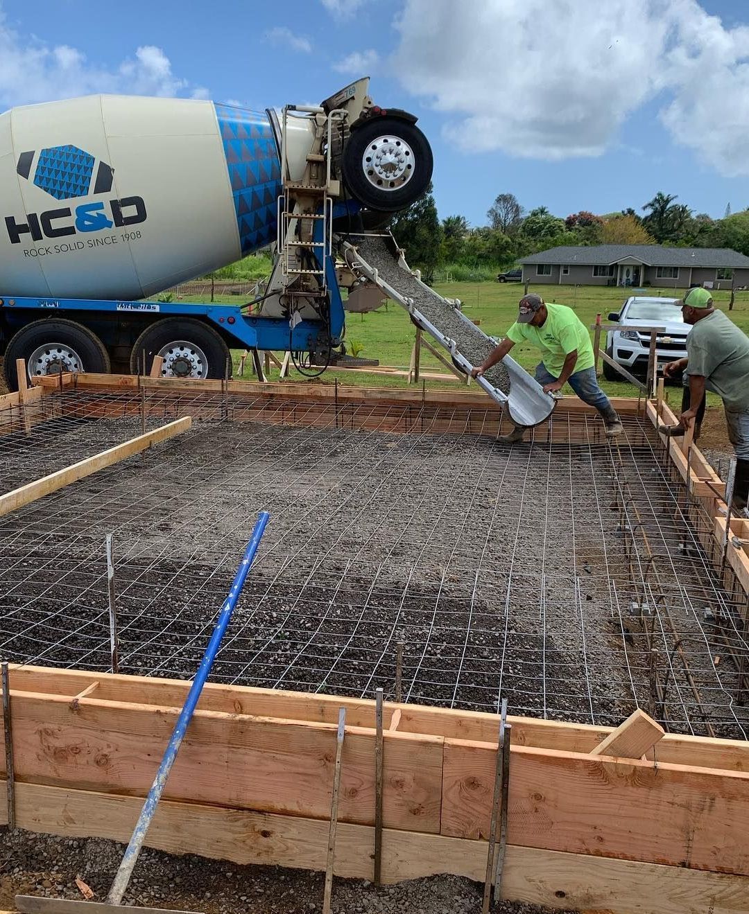 A concrete mixer is pouring concrete into a foundation