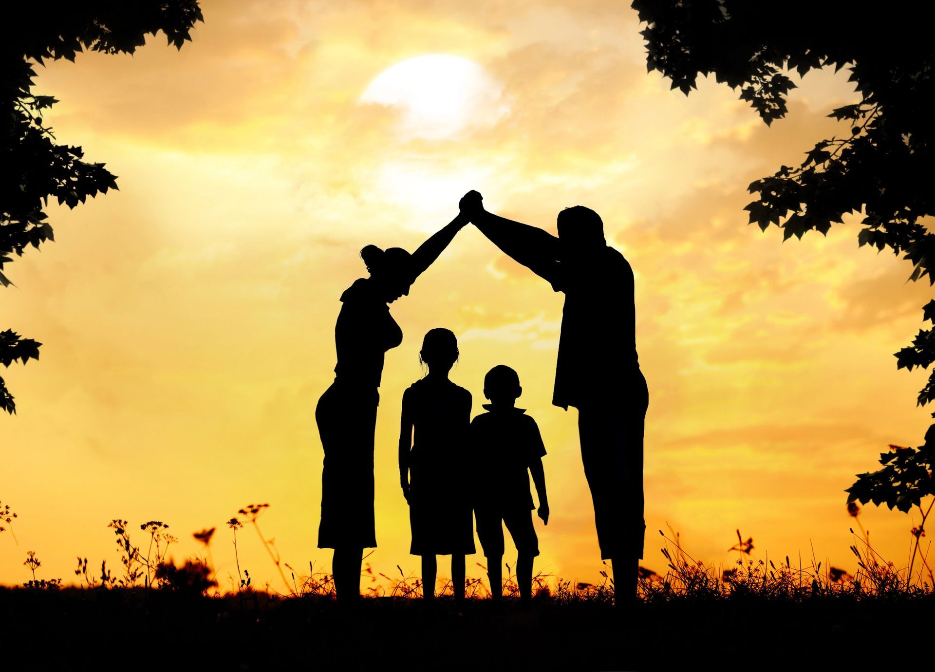 A silhouette of a family giving each other a high five