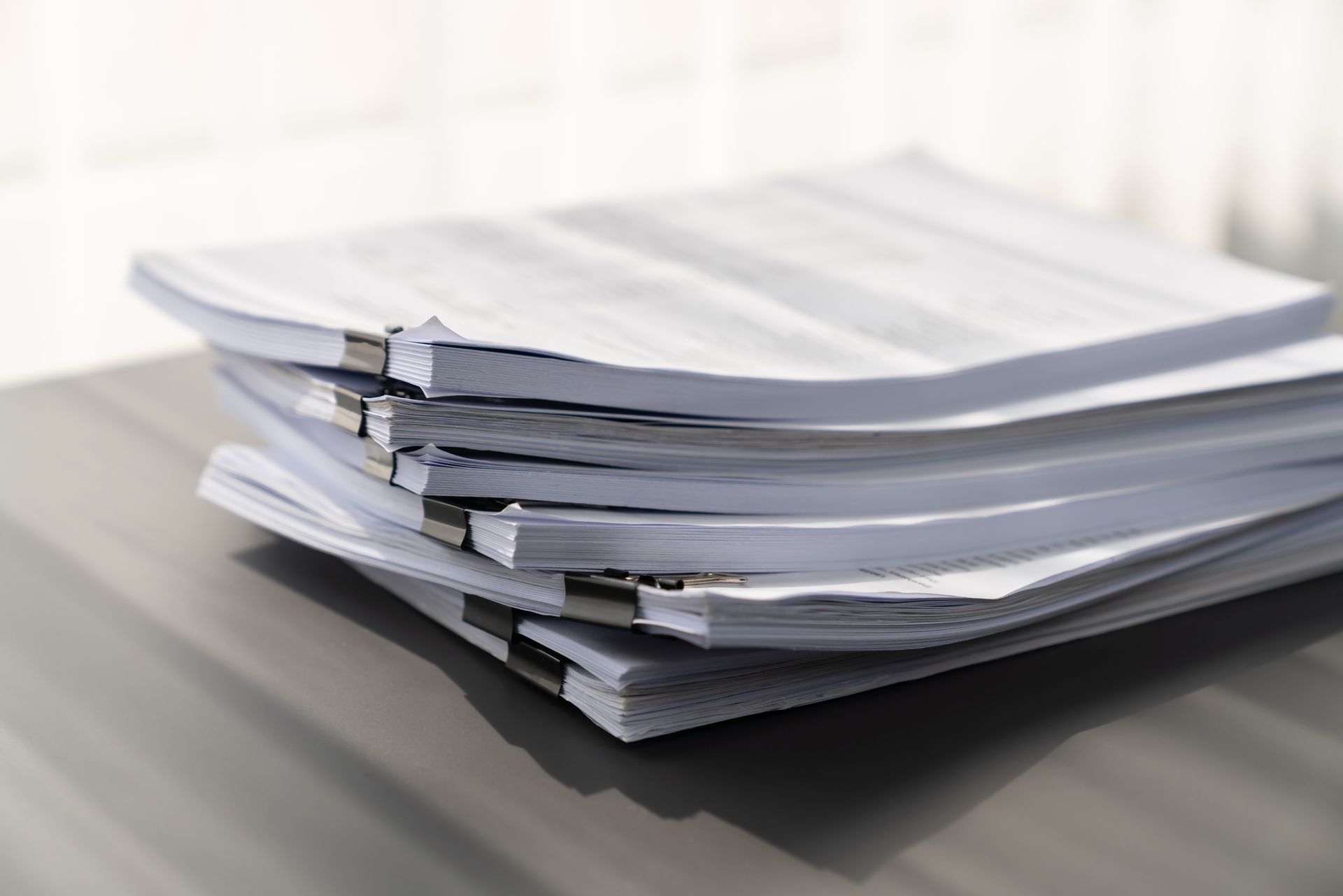 A stack of papers sitting on top of each other on a table.