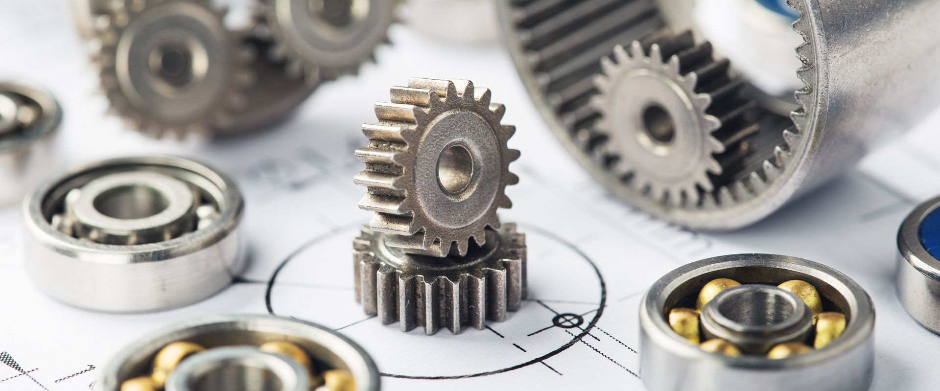 There are many different types of gears and bearings on the table.