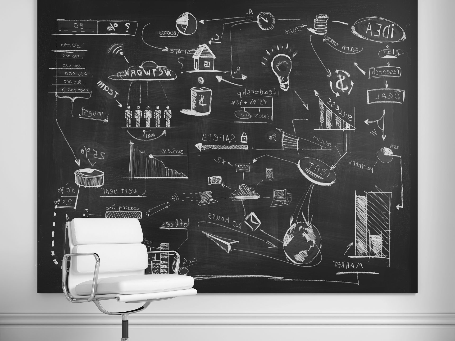 A chair is sitting in front of a large blackboard with drawings on it.