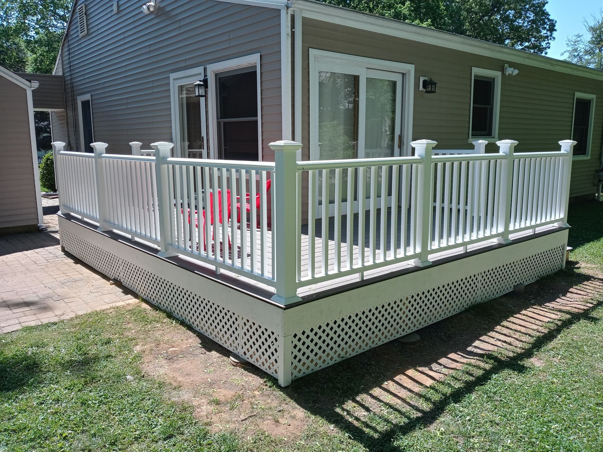 A small house with a white deck in front of it