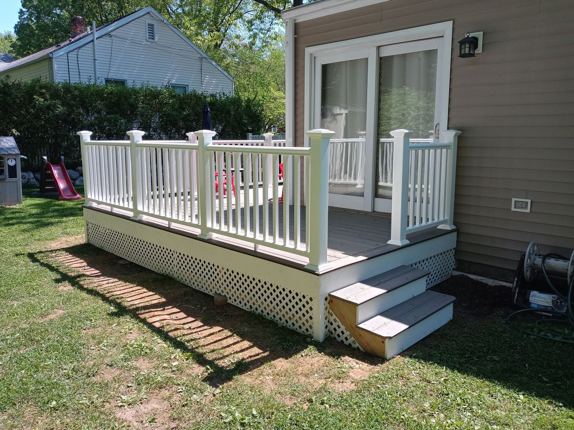 A house with a deck and stairs in front of it