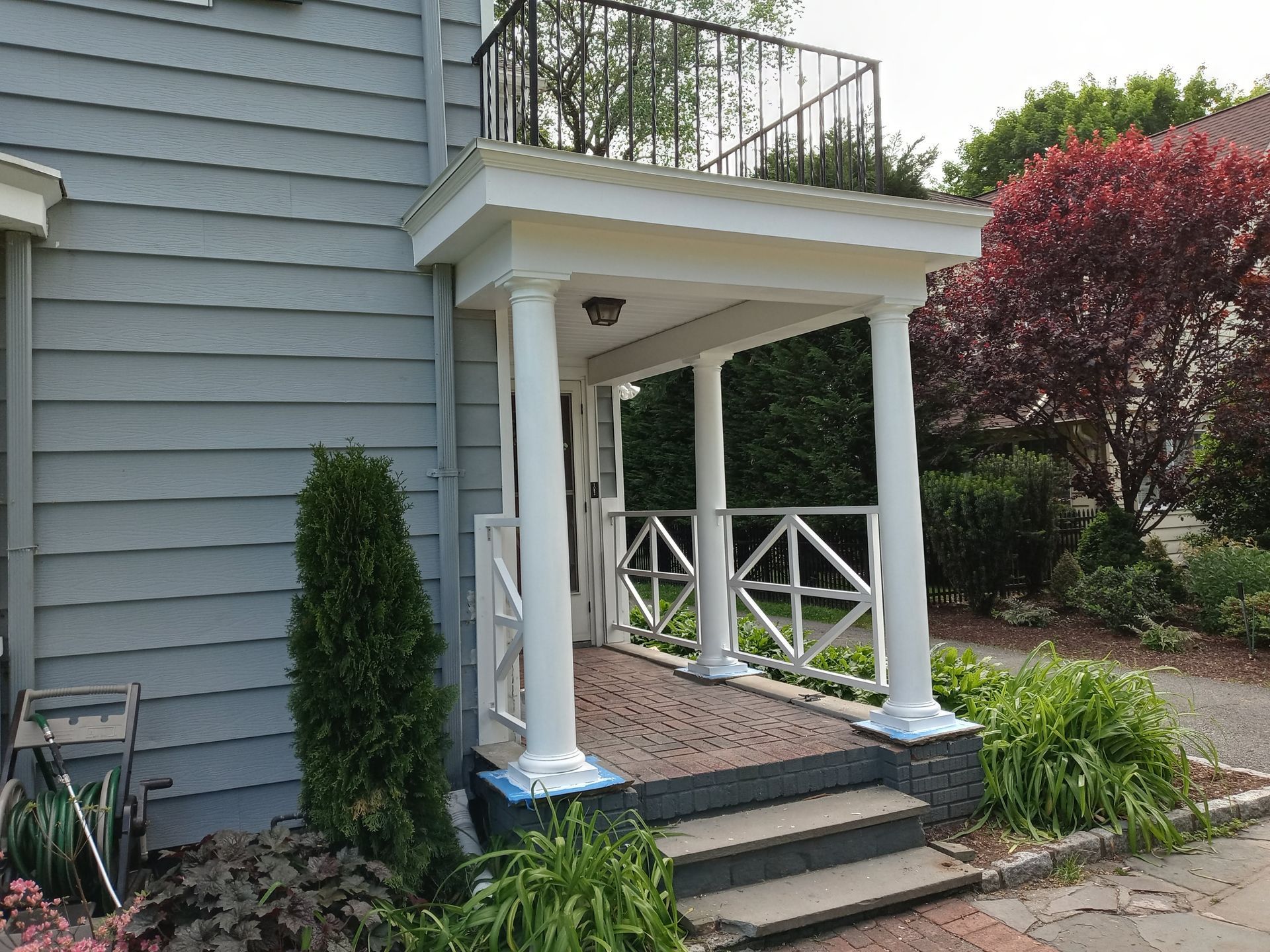 A house with a porch and stairs leading up to it