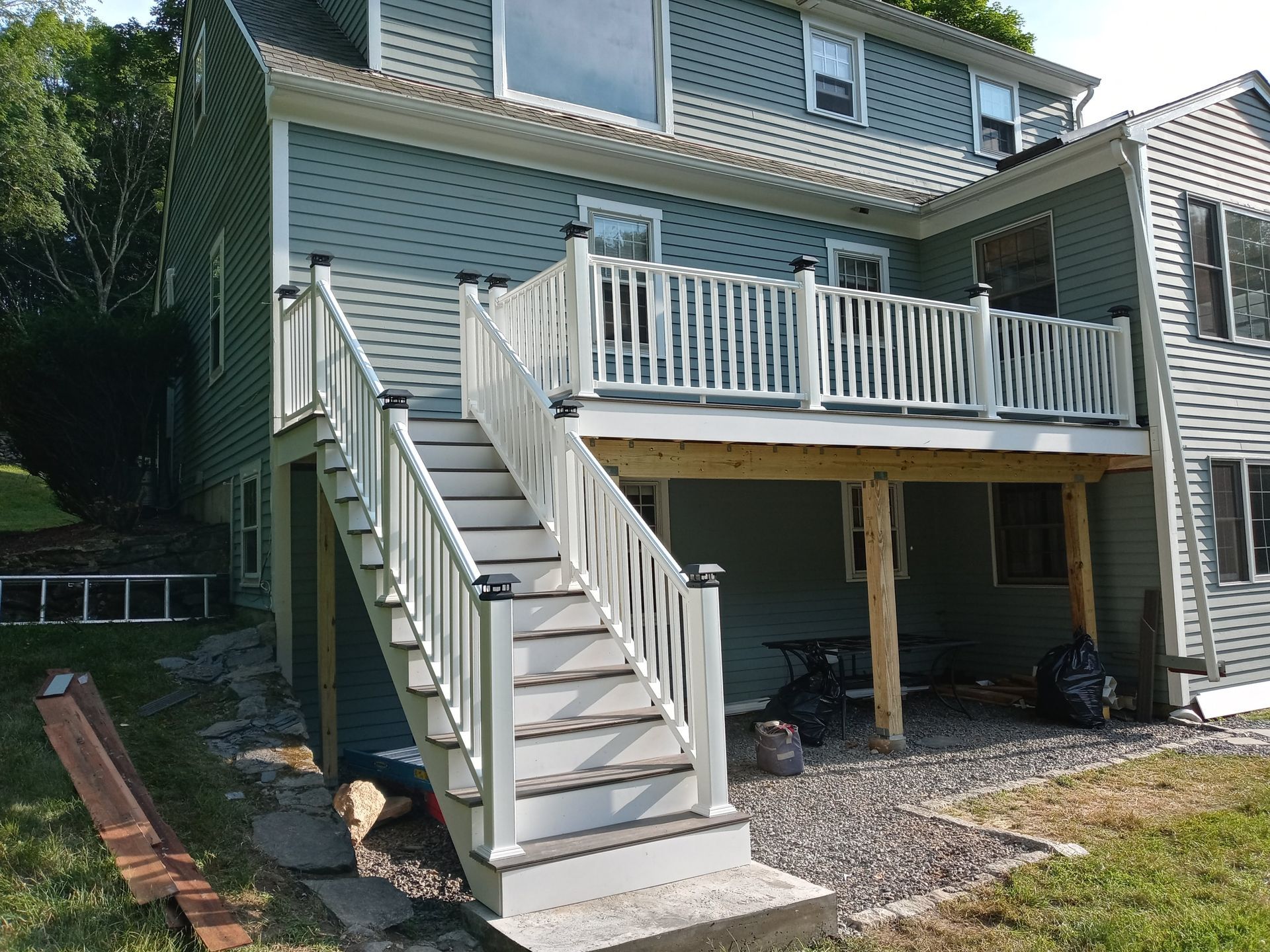 A house with a deck and stairs leading up to it