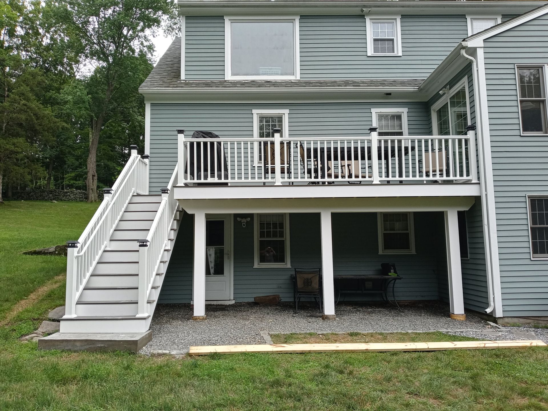 The back of a house with a deck and stairs.
