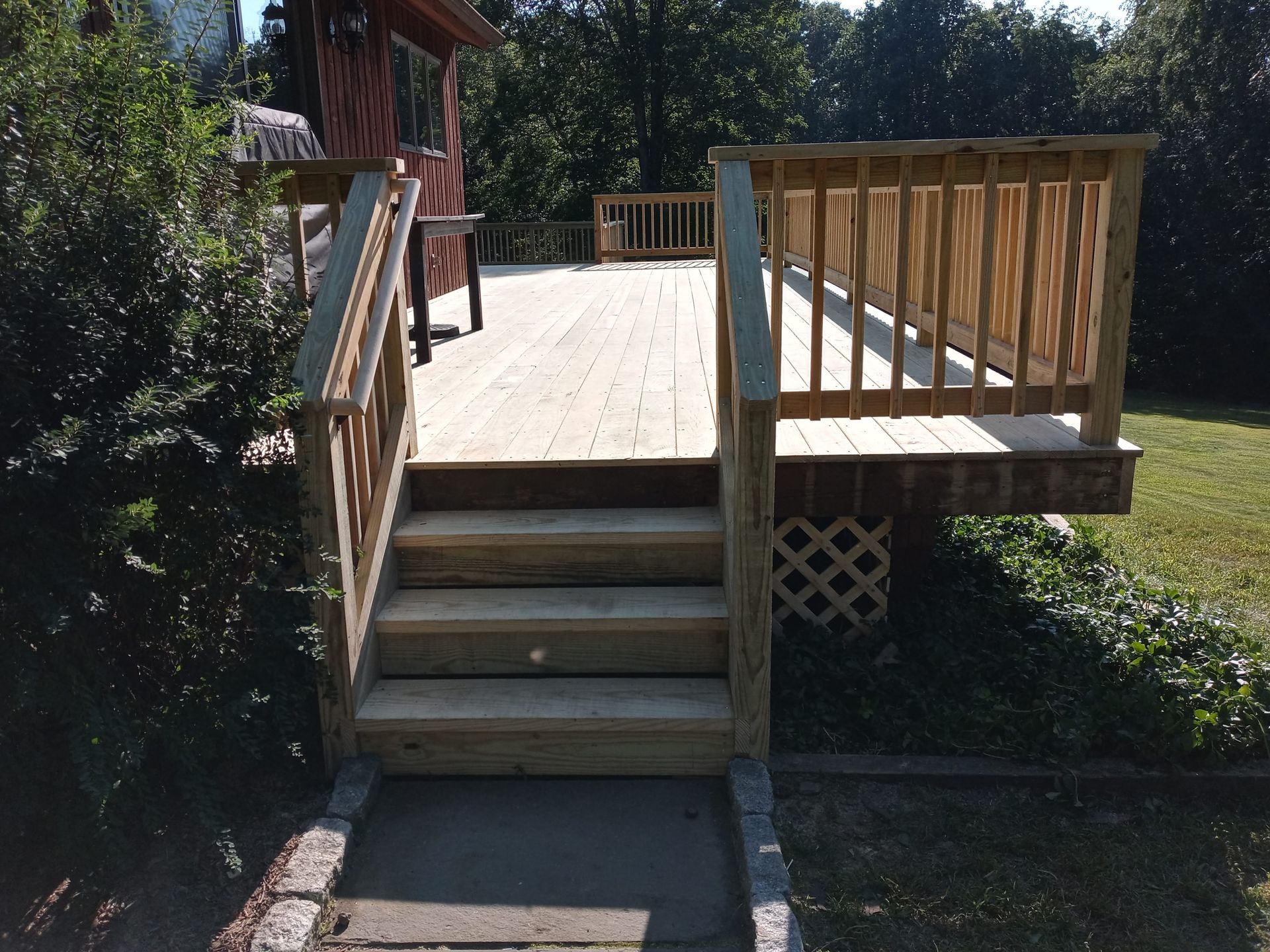 A wooden deck with stairs leading up to it