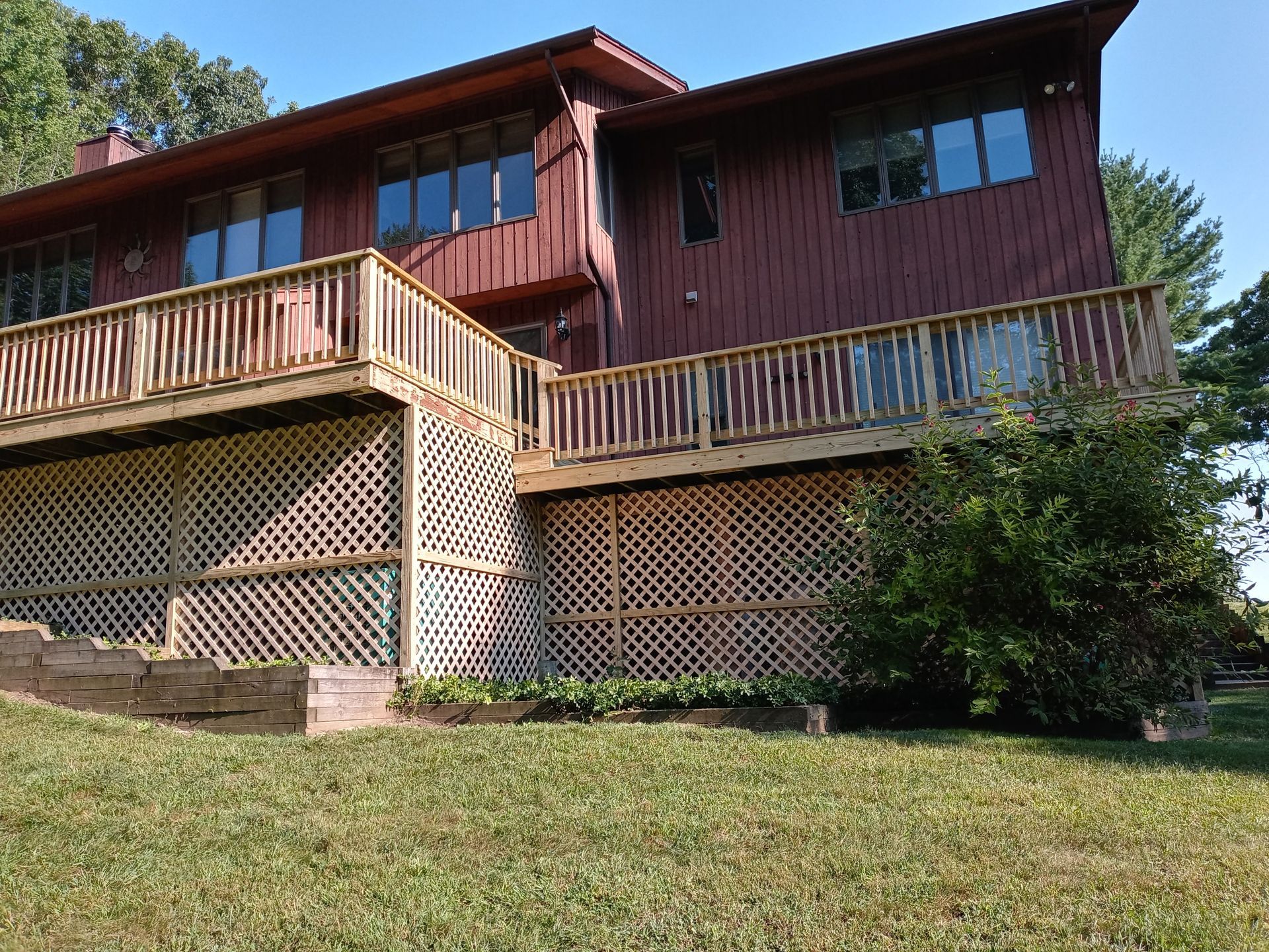 A large house with a large deck on the side of it.