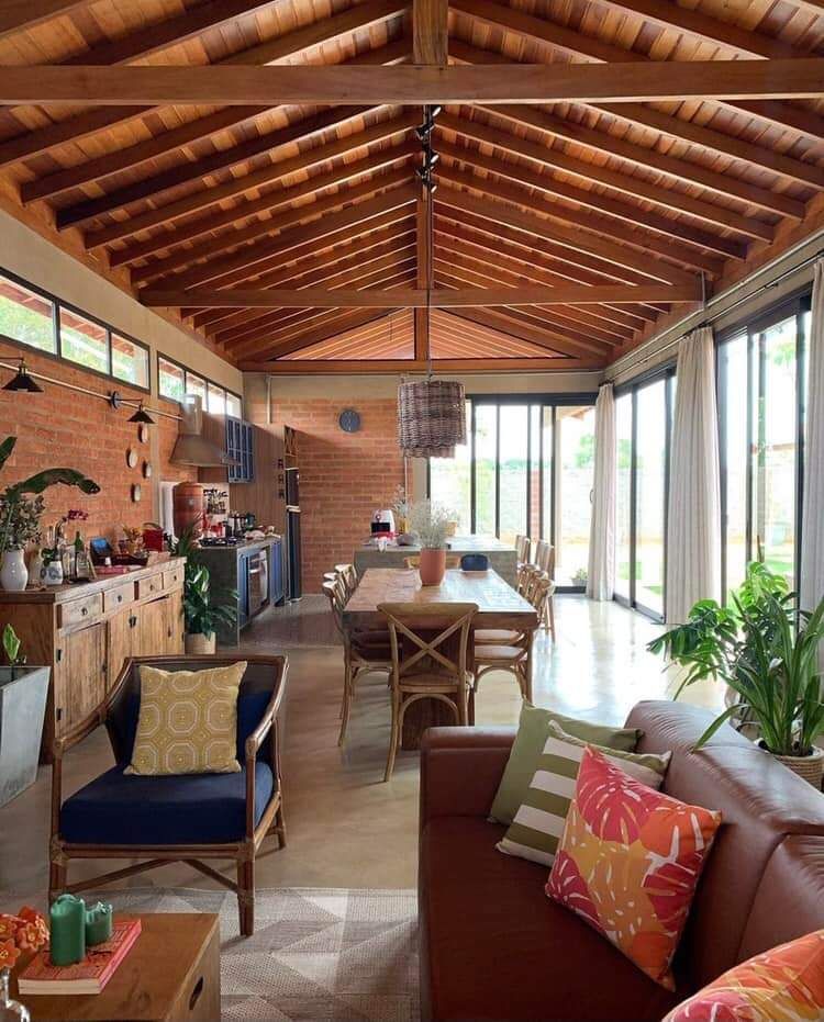 A living room filled with furniture and a wooden ceiling.