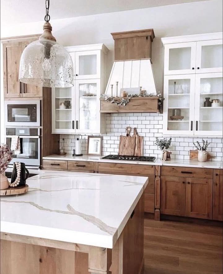 A kitchen with wooden cabinets and a white counter top.