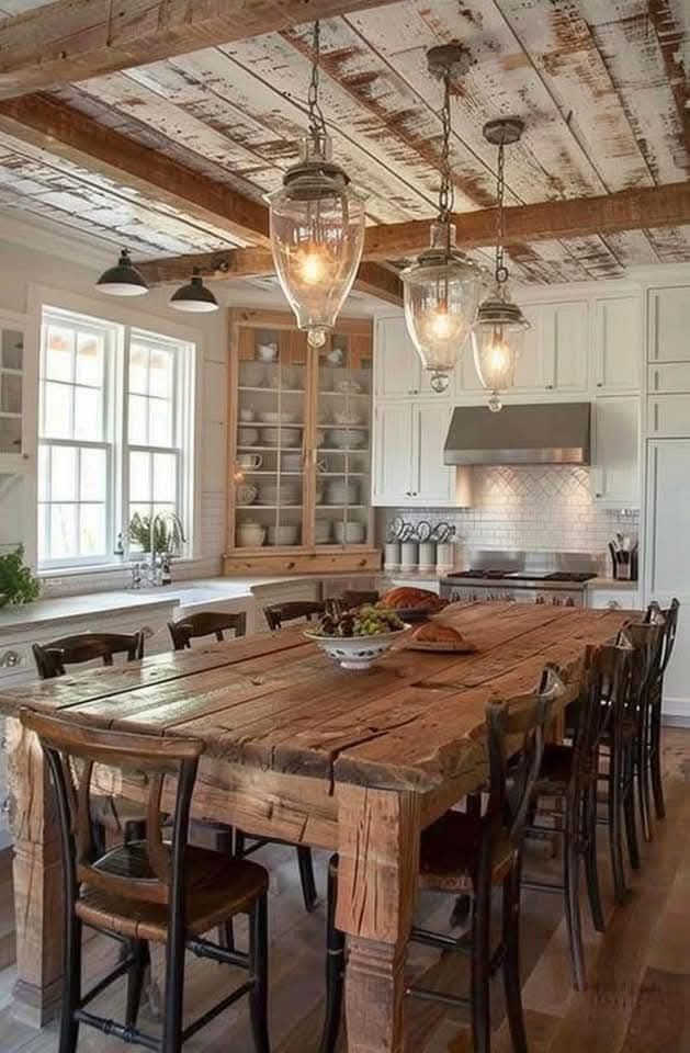 A kitchen with a wooden table and chairs and a wooden ceiling.
