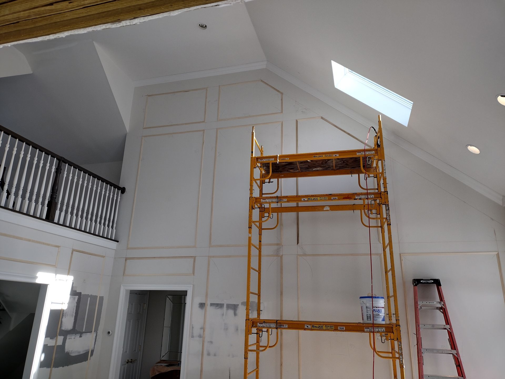 A large room with a ladder and a scaffolding in it.