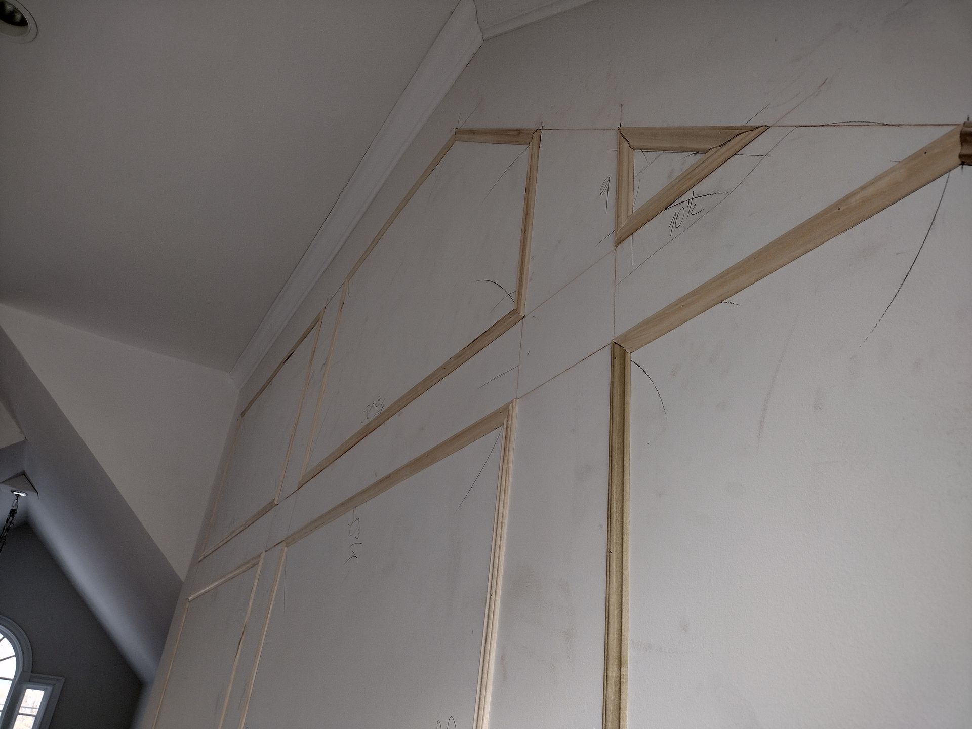 A white wall with a wooden frame on it