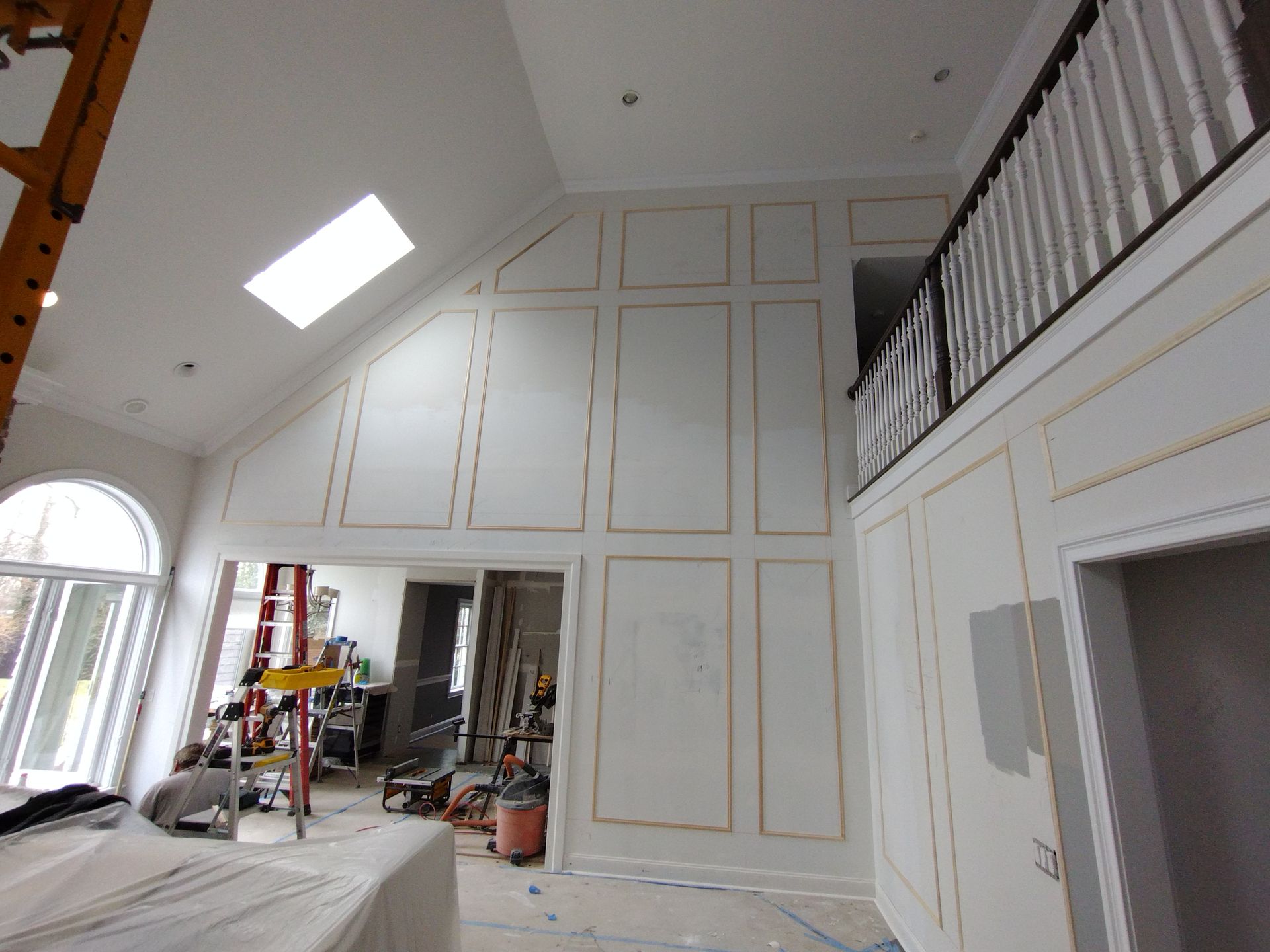 A large room with a ladder in the middle of it