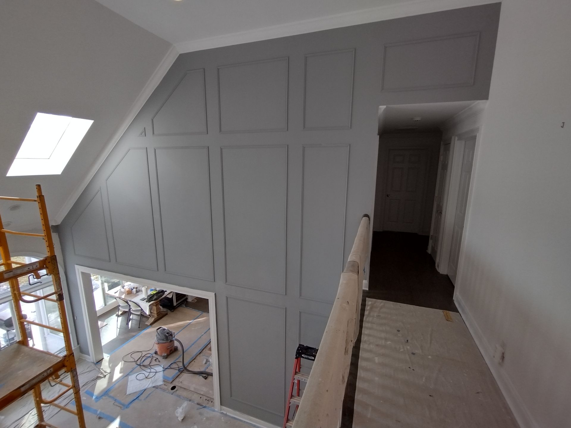 A view of a hallway from the second floor of a house under construction.