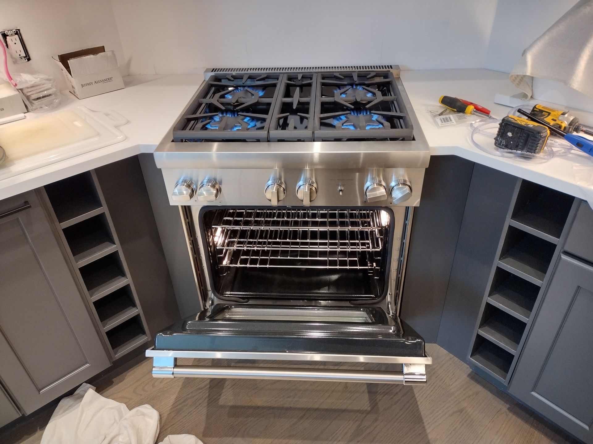 A stove with the door open in a kitchen