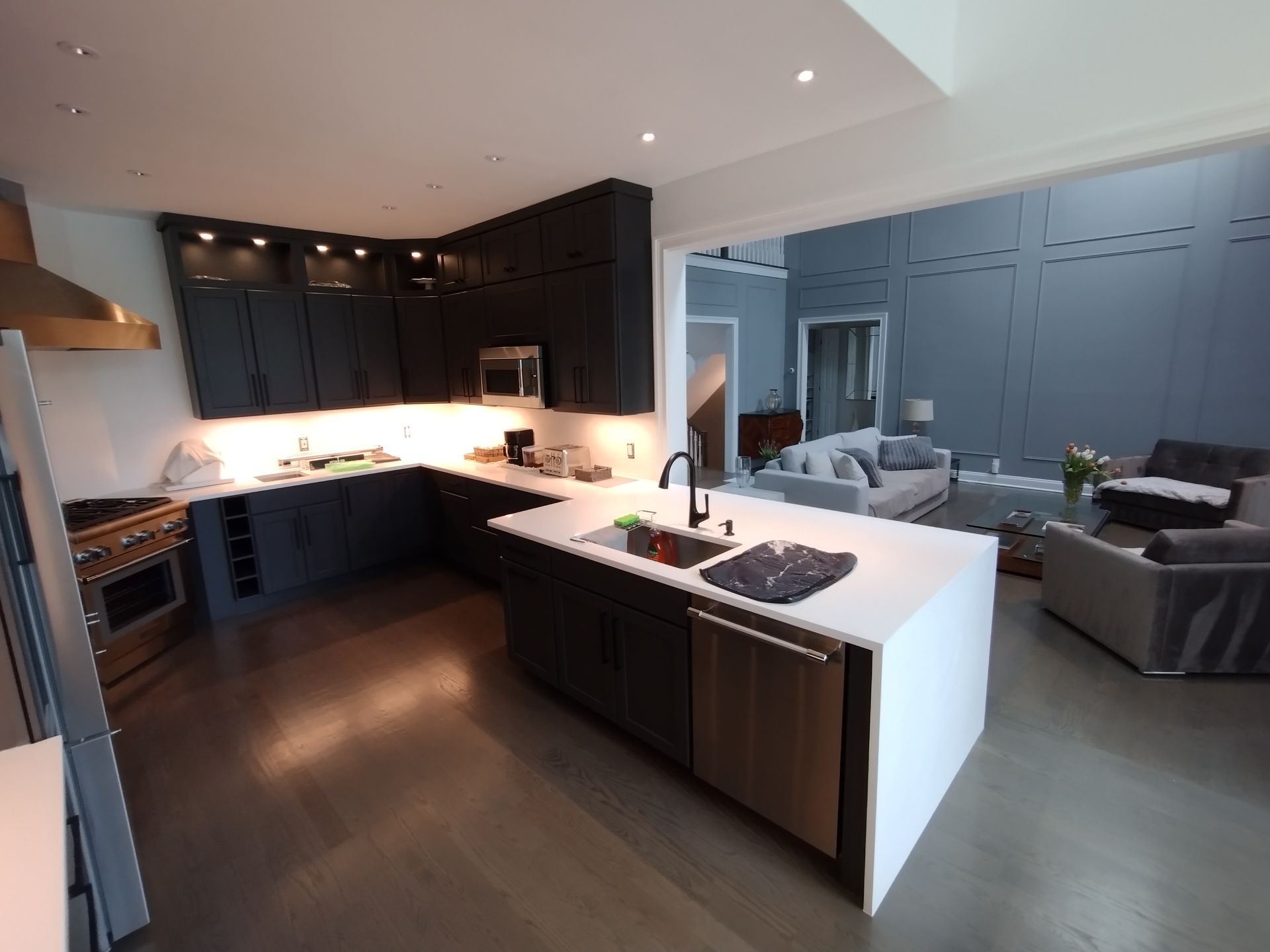 A kitchen with a large island and stainless steel appliances